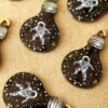 6 pc. Enameled Astronaut in Space in a Lightbulb Charms, Black, White, and Gold, 27mm x 16.5mm | MIS-394
